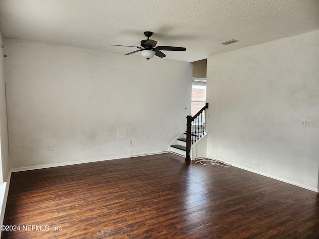 spare room featuring a textured ceiling, ceiling fan, and dark hardwood / wood-style floors