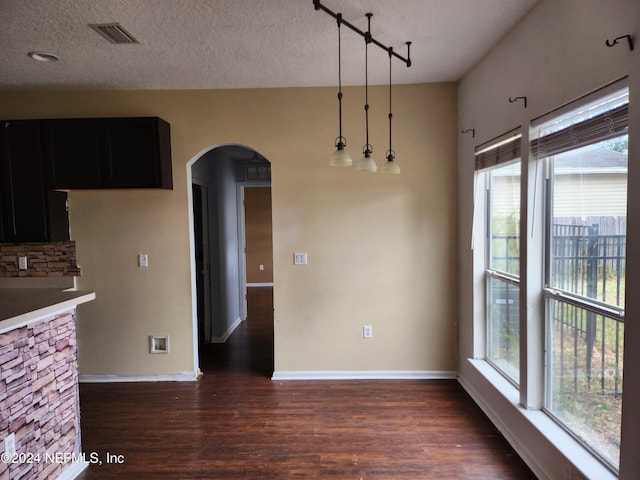 kitchen featuring plenty of natural light, dark hardwood / wood-style floors, and a textured ceiling