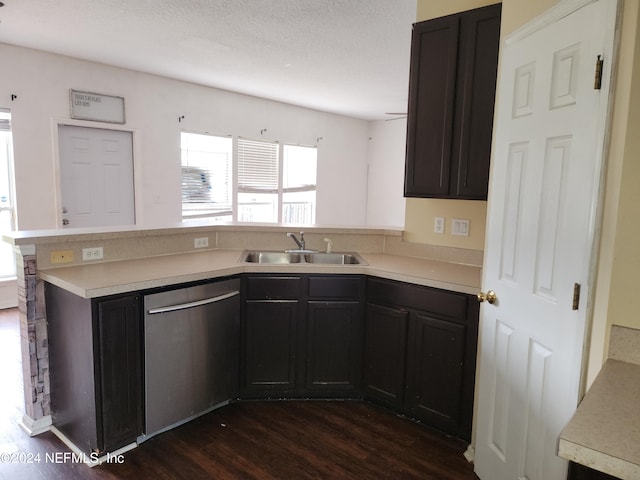 kitchen with kitchen peninsula, a textured ceiling, sink, dishwasher, and dark hardwood / wood-style floors