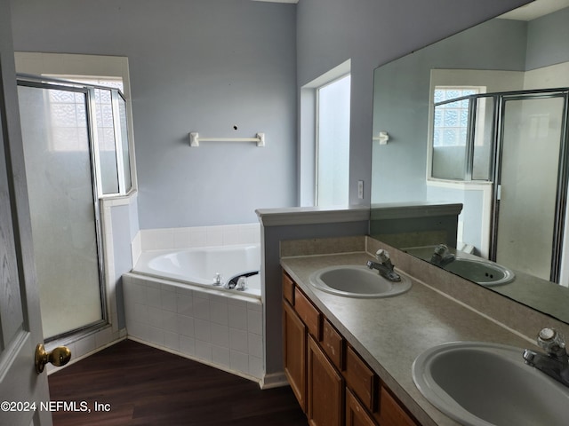 bathroom featuring vanity, hardwood / wood-style flooring, a wealth of natural light, and independent shower and bath