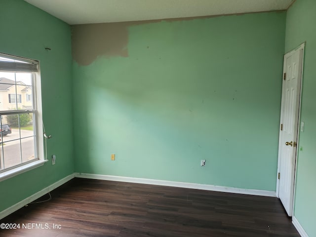 empty room featuring dark hardwood / wood-style flooring