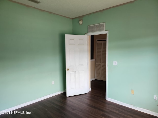 unfurnished room featuring dark hardwood / wood-style floors