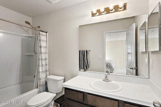 full bathroom with shower / bath combo with shower curtain, vanity, a textured ceiling, and toilet