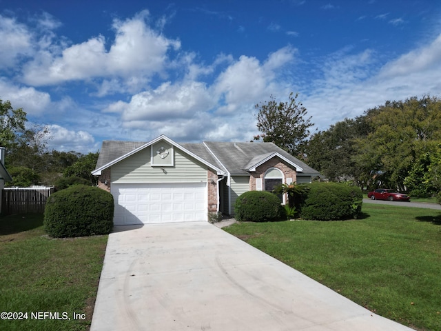 view of front of home with a garage and a front lawn