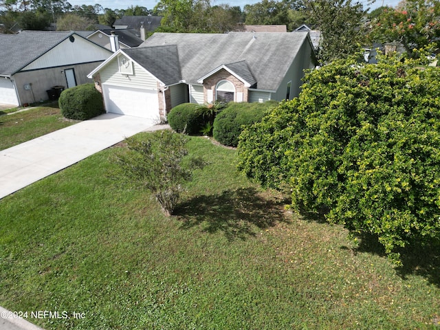 view of front of house with a garage and a front yard