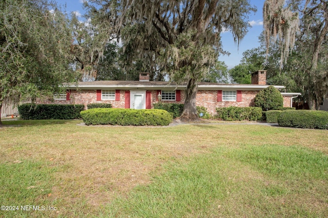 ranch-style home with a front lawn