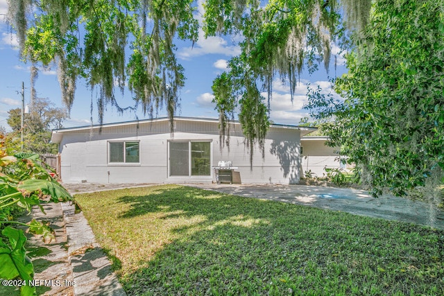 rear view of house with a yard