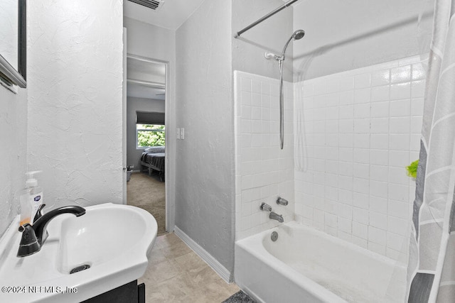 bathroom with tile patterned flooring, vanity, and shower / tub combo