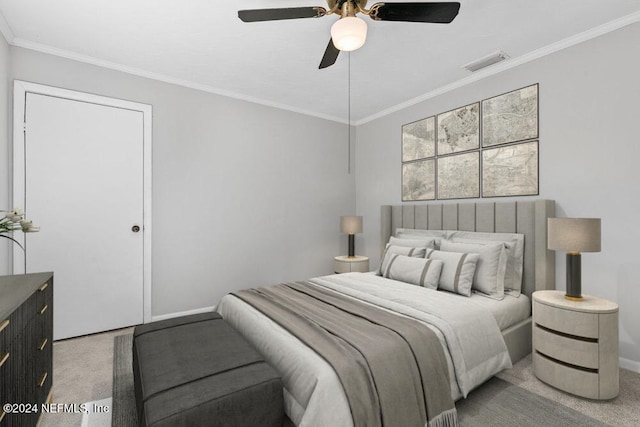 carpeted bedroom with ceiling fan and ornamental molding