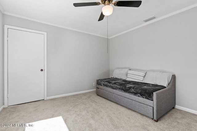 sitting room featuring light carpet, ceiling fan, and ornamental molding