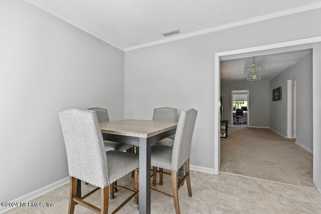 dining area featuring light carpet, crown molding, and a notable chandelier