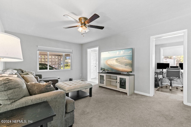 carpeted living room with ceiling fan and plenty of natural light