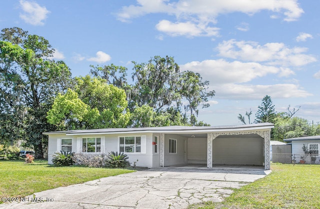 single story home featuring a carport and a front lawn