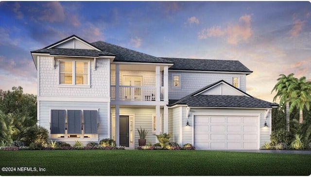 view of front facade with a lawn, a balcony, and a garage