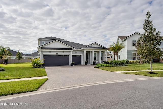 view of front of home with a front lawn and a garage