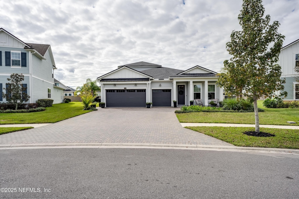 view of front of home with a front lawn and a garage