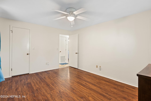 unfurnished bedroom featuring dark hardwood / wood-style flooring and ceiling fan