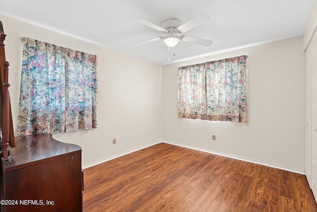 unfurnished room featuring ceiling fan and dark hardwood / wood-style flooring