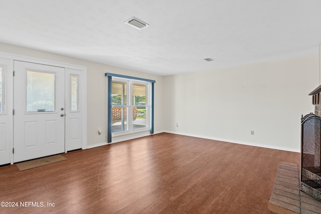 unfurnished living room with hardwood / wood-style flooring