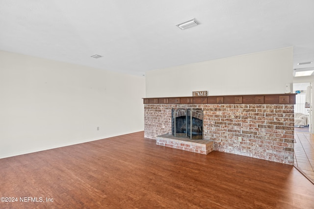 unfurnished living room with a fireplace and hardwood / wood-style floors