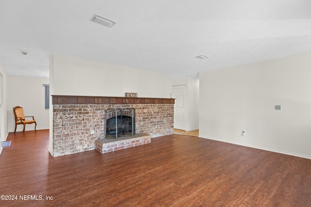 unfurnished living room with a fireplace and dark hardwood / wood-style floors