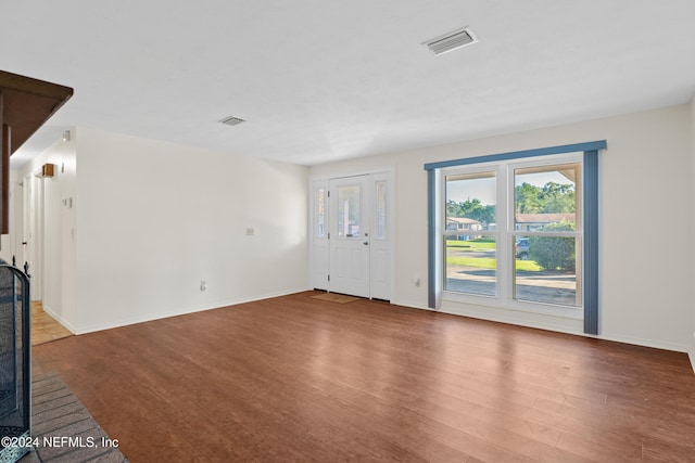 unfurnished living room featuring hardwood / wood-style flooring