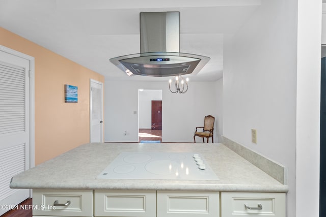 kitchen featuring white cabinets, white electric cooktop, kitchen peninsula, and island range hood