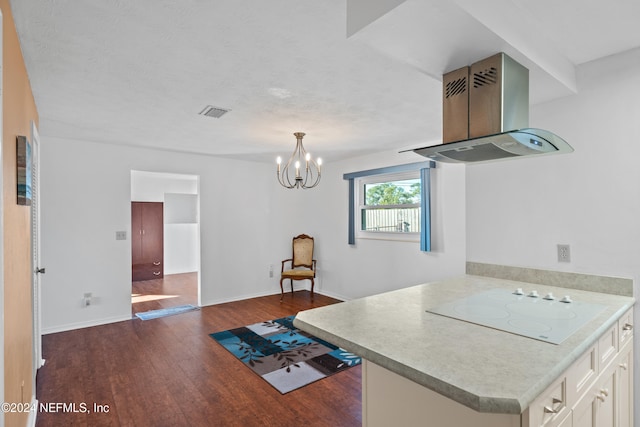 kitchen featuring an inviting chandelier, white electric stovetop, dark hardwood / wood-style flooring, kitchen peninsula, and island exhaust hood