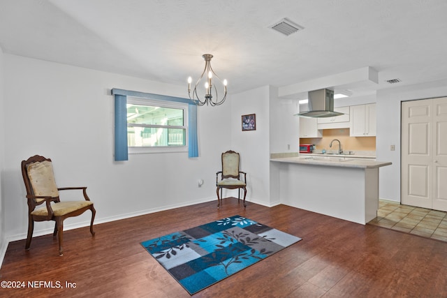 sitting room with a chandelier, sink, and dark wood-type flooring