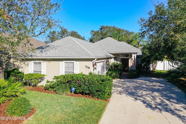 view of front of home with a garage and a front yard