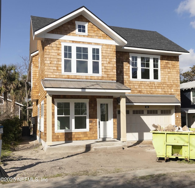 view of front of house with covered porch, a standing seam roof, central AC, metal roof, and a garage