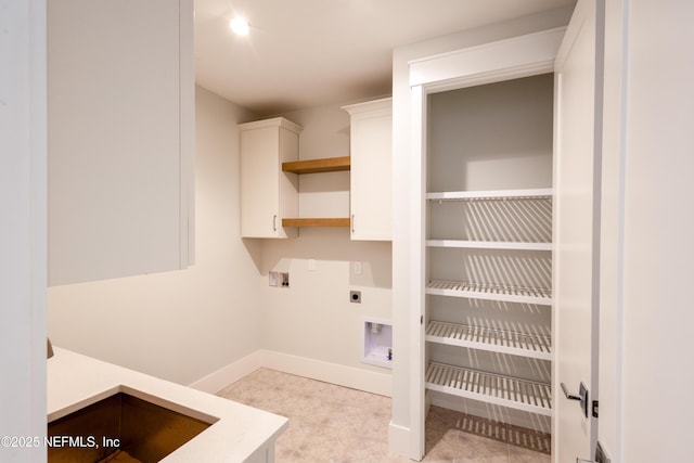 washroom with washer hookup, cabinet space, electric dryer hookup, and baseboards