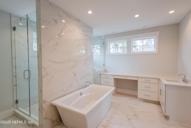 bathroom featuring marble finish floor, a marble finish shower, recessed lighting, a soaking tub, and vanity