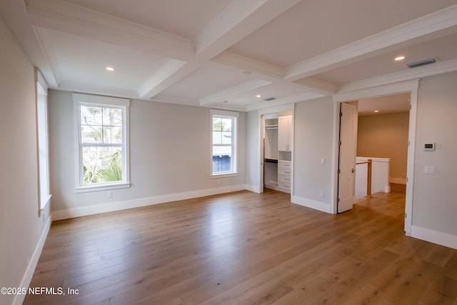 unfurnished room with coffered ceiling, beamed ceiling, light wood-style flooring, and baseboards