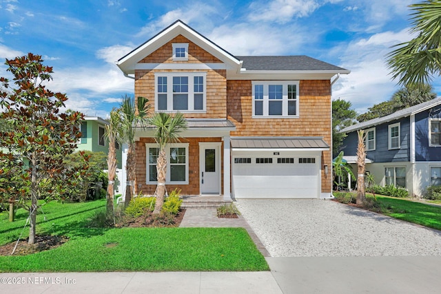 142 Ocean Blvd, Atlantic Beach, FL 32233 - view of front of home featuring gravel driveway, a garage, a front yard, a standing seam roof, and roof with shingles