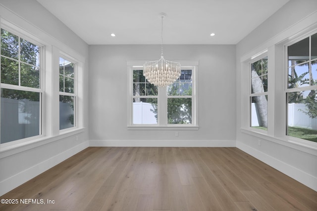 142 Ocean Blvd, Atlantic Beach, FL 32233 - unfurnished dining area featuring healthy amount of natural light, a chandelier, light wood-style flooring, and recessed lighting