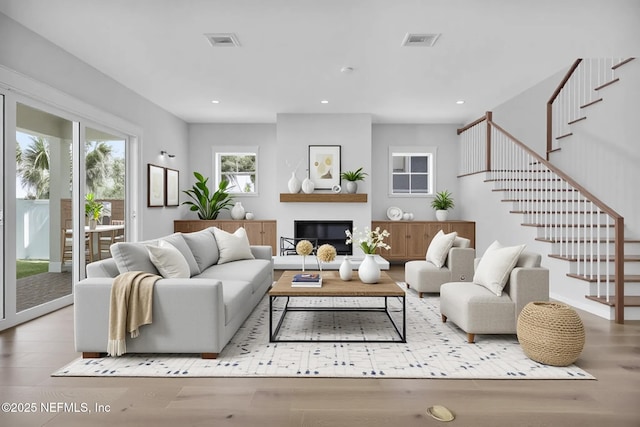 142 Ocean Blvd, Atlantic Beach, FL 32233 - living area featuring wood finished floors, stairway, recessed lighting, and a glass covered fireplace