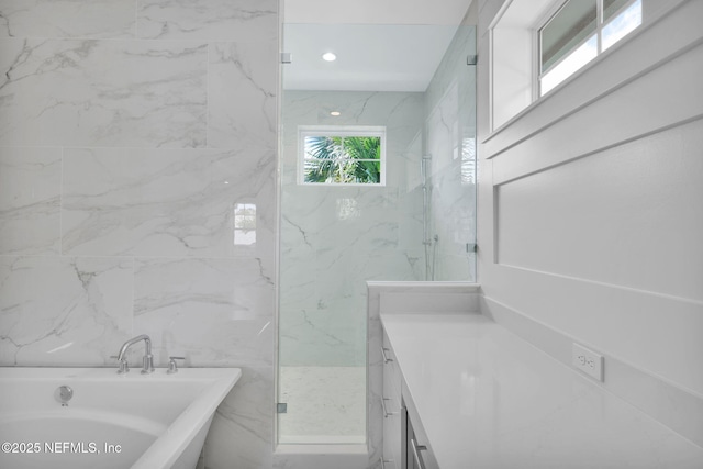 142 Ocean Blvd, Atlantic Beach, FL 32233 - full bathroom with a freestanding bath, vanity, a marble finish shower, tile walls, and recessed lighting