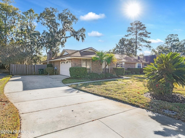 ranch-style home with a garage and a front lawn