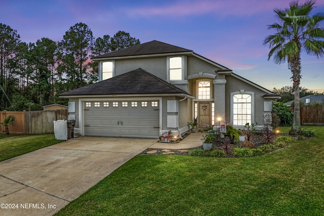 front facade featuring a lawn and a garage