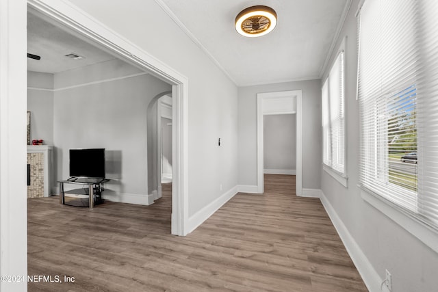 hall featuring hardwood / wood-style flooring and crown molding