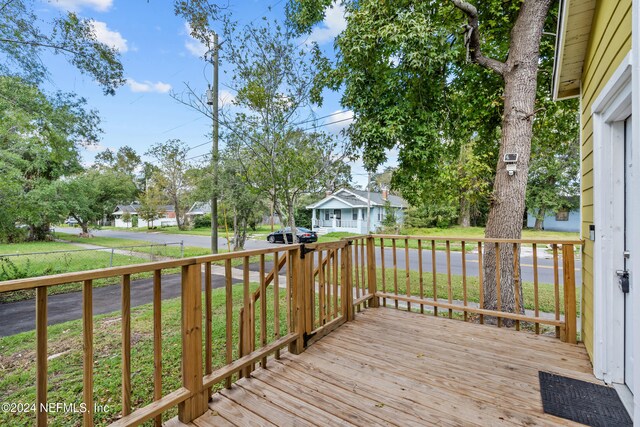 wooden terrace with a yard