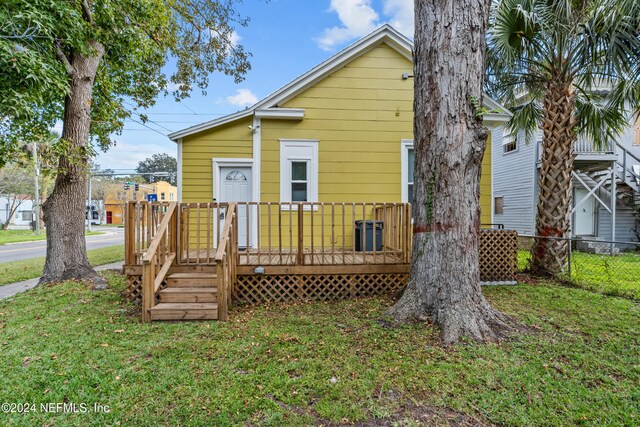 rear view of house with a yard