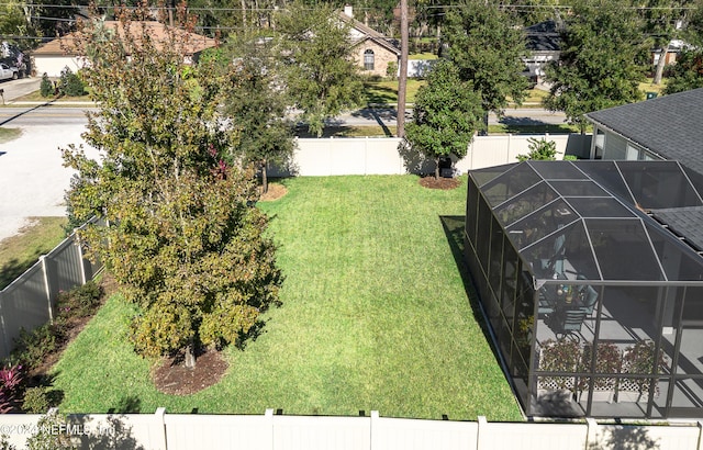 view of yard with glass enclosure