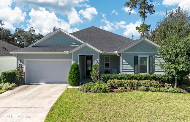 view of front of property with a front lawn and a garage