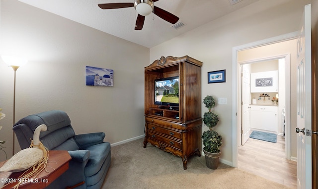 sitting room with light carpet and ceiling fan