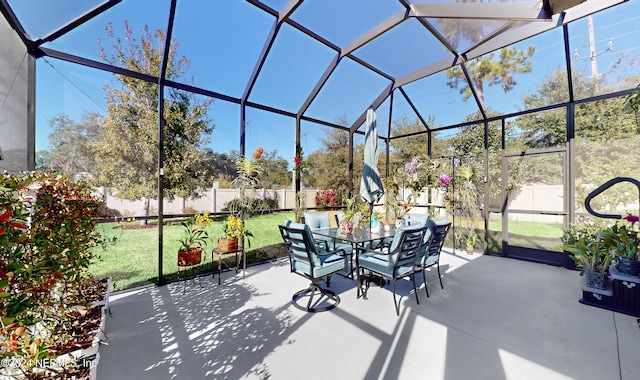 view of patio featuring glass enclosure