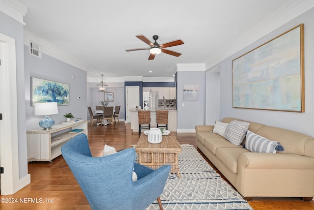 living room with ceiling fan, dark hardwood / wood-style floors, and ornamental molding