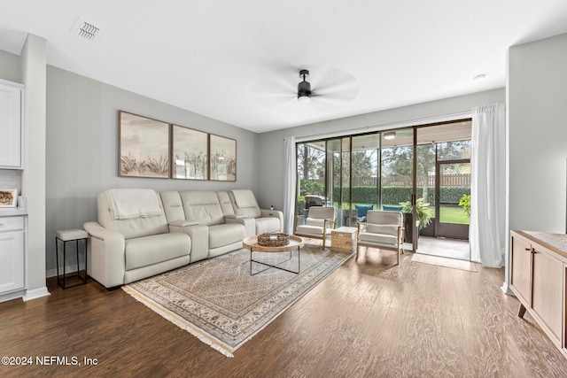 living room with ceiling fan and dark hardwood / wood-style flooring