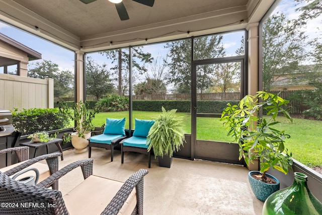 sunroom featuring ceiling fan